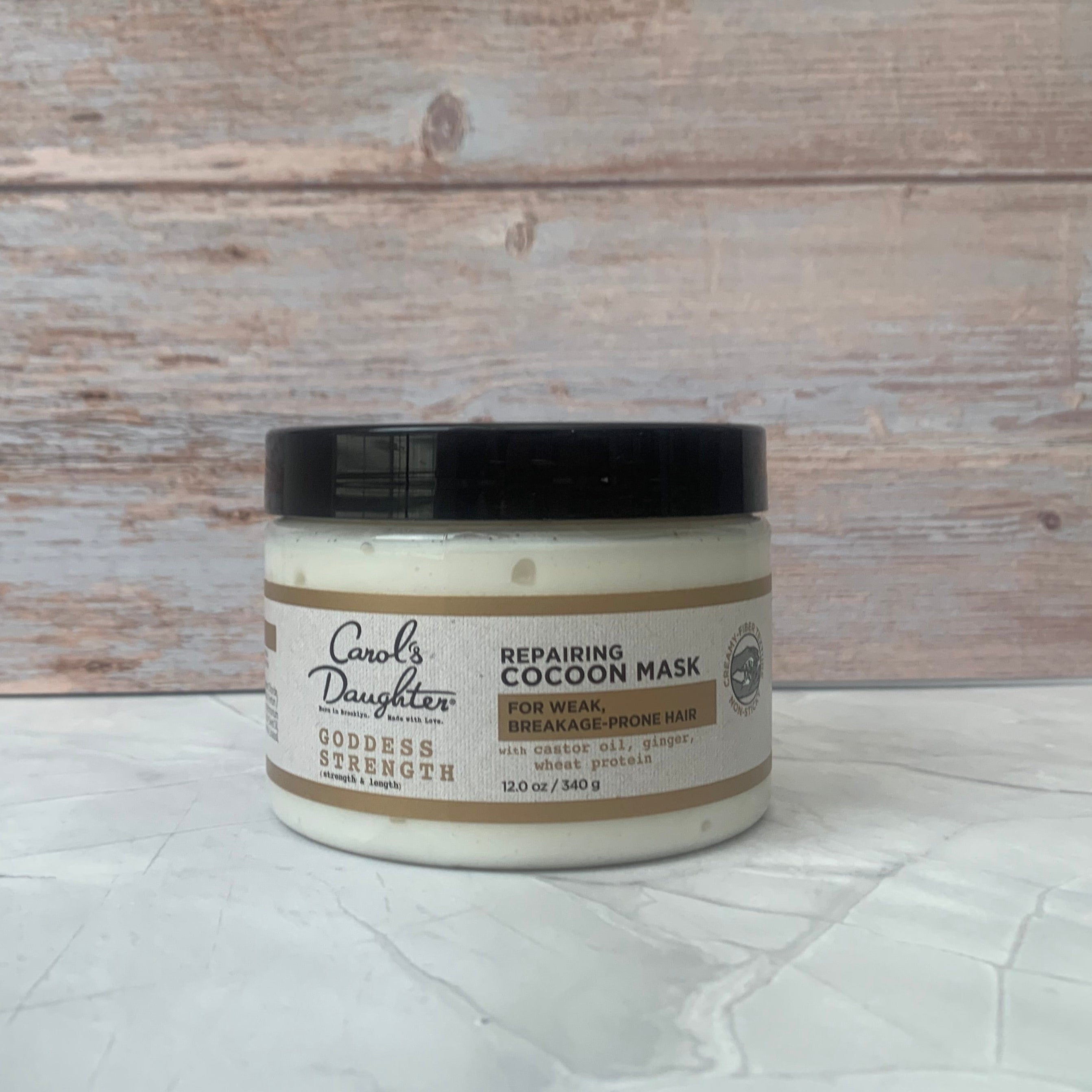 Carol's Daughter Goddess Repairing Cocoon Mask in 12 oz jar for deep hydration and hair strengthening.